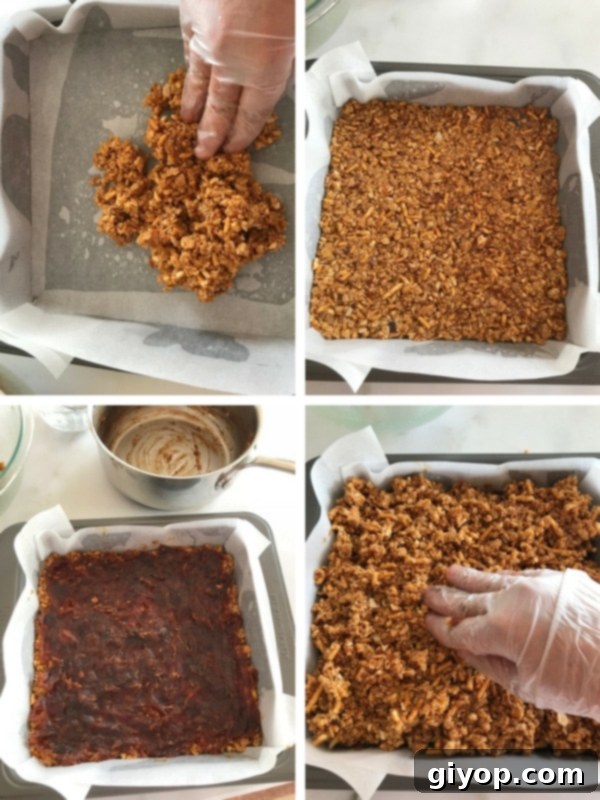 Assembling the breakfast squares by pressing half the mixture, spreading date paste, then topping with the remaining mixture, creating distinct layers.