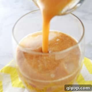 Homemade Sweet Tamarind Juice 3 A photo showing a glass of Tamarind juice is being poured