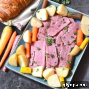 An overhead image of sliced corned beef with vegetables.
