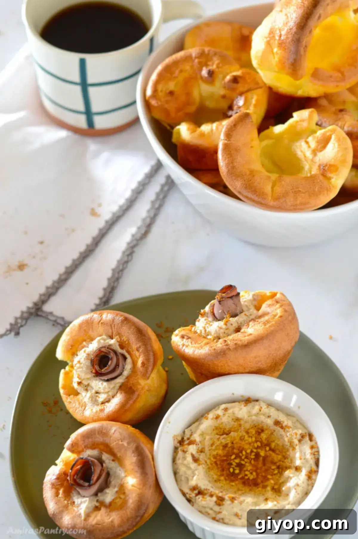 A top view of a breakfast table with yorkshire pudding filled with roast beef and cheese.