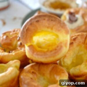 One hollow yorkshire pudding on top of a stack on a plate.