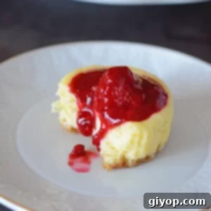 Raspberry Cheesecake Bites 5 A close up of cupcake on a plate, with Cream cheese and raspberry