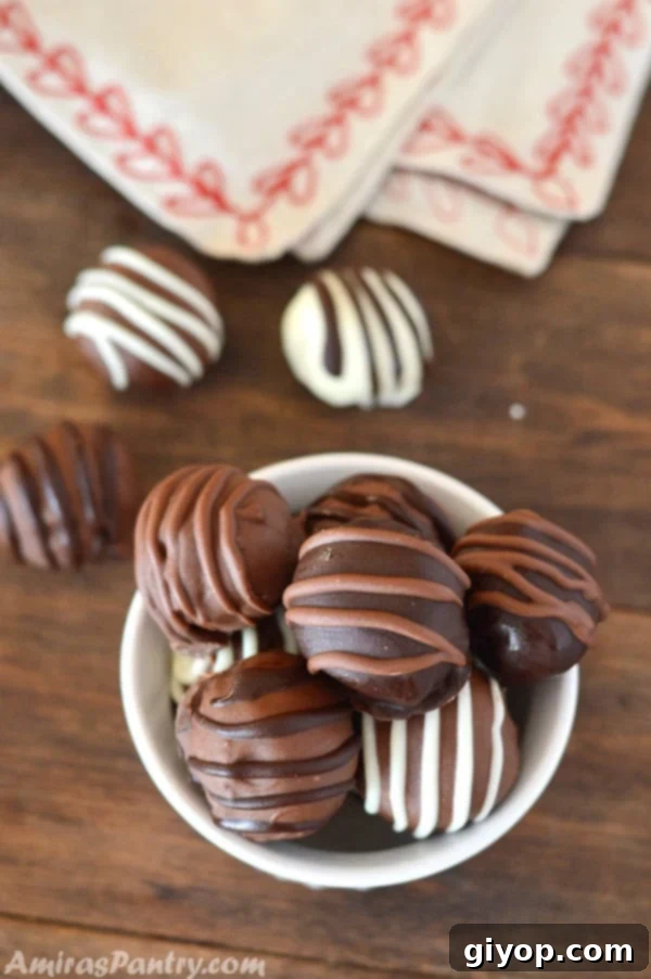 Chocolate Chip Cookie dough truffles in a white bowl with some truffles on the table
