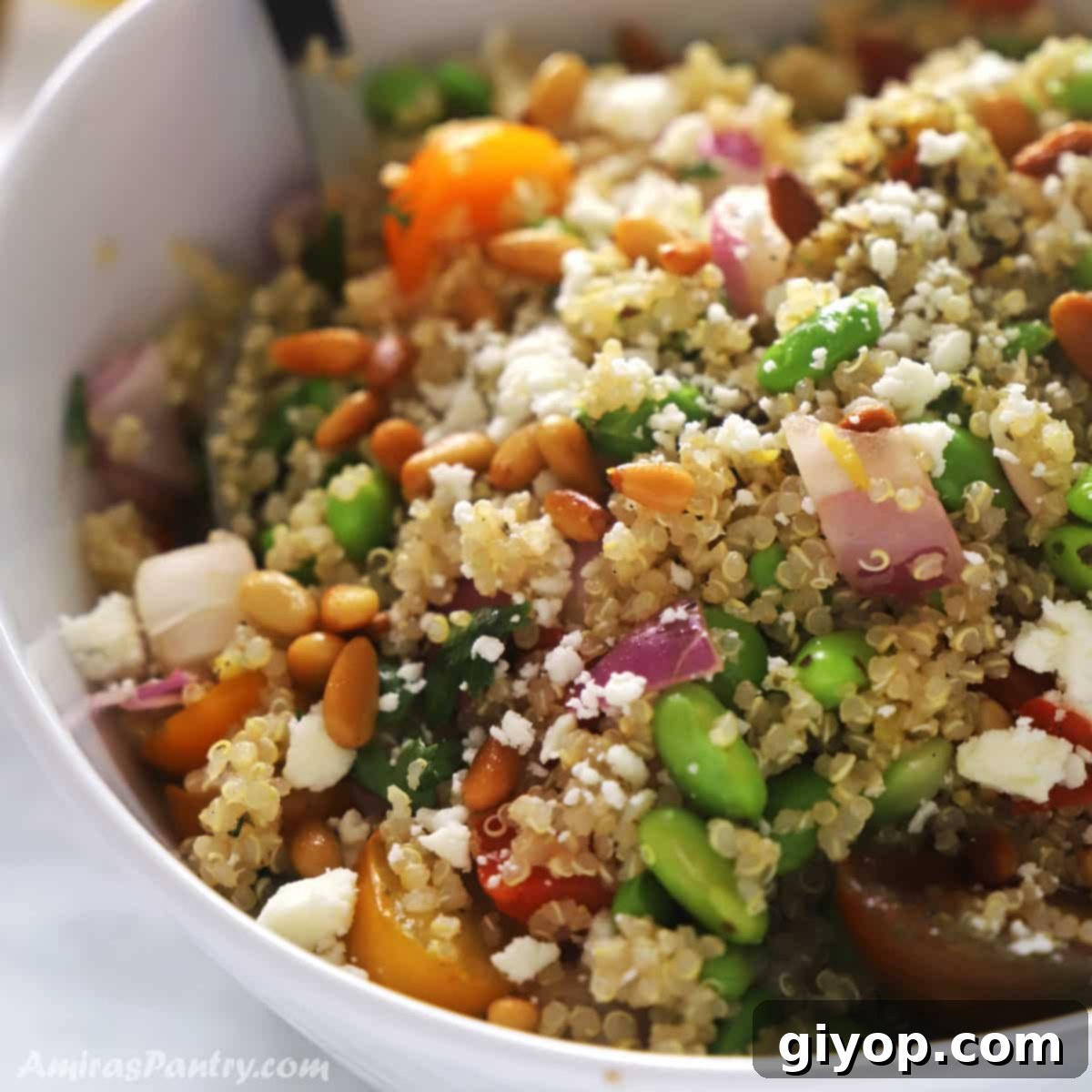 Vibrant Edamame Quinoa Medley 2 A quinoa veggie bowl with edamame with a serving spoon in it