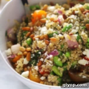 Vibrant Edamame Quinoa Medley 4 A quinoa veggie bowl with edamame with a serving spoon in it