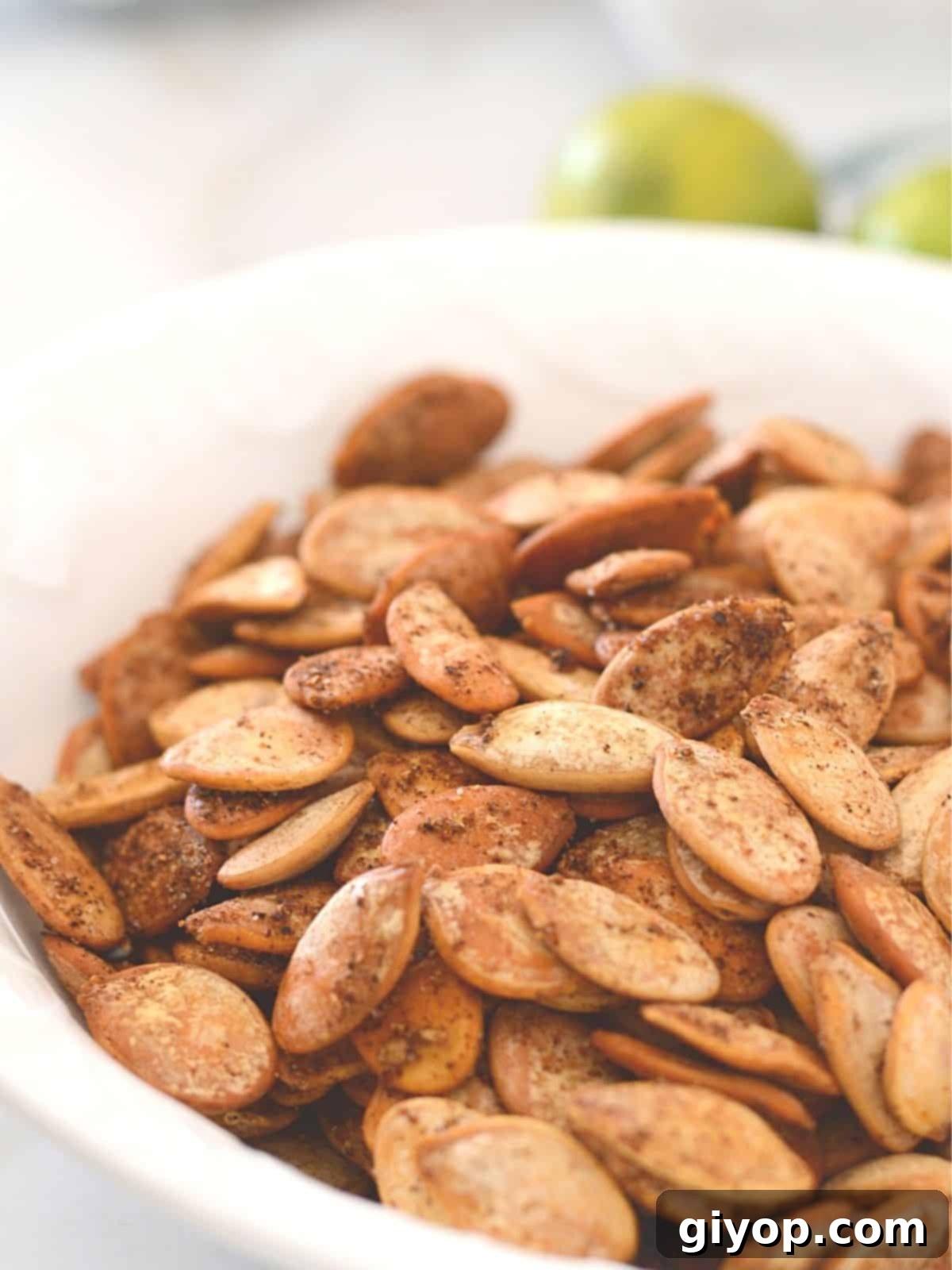 Blazing Pumpkin Seed Crunch 2 A close up look at a white plate with spicy roasted pumpkin seeds.
