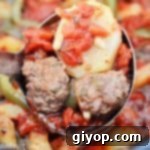 A ladle scooping some meatballs and potato from the crockpot, highlighting the comforting texture.