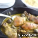 A bowl of creamy tahini chicken stew, rich in color and texture.