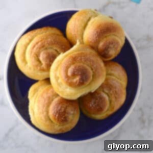 A top view of a pile of rolls on a blue plate.