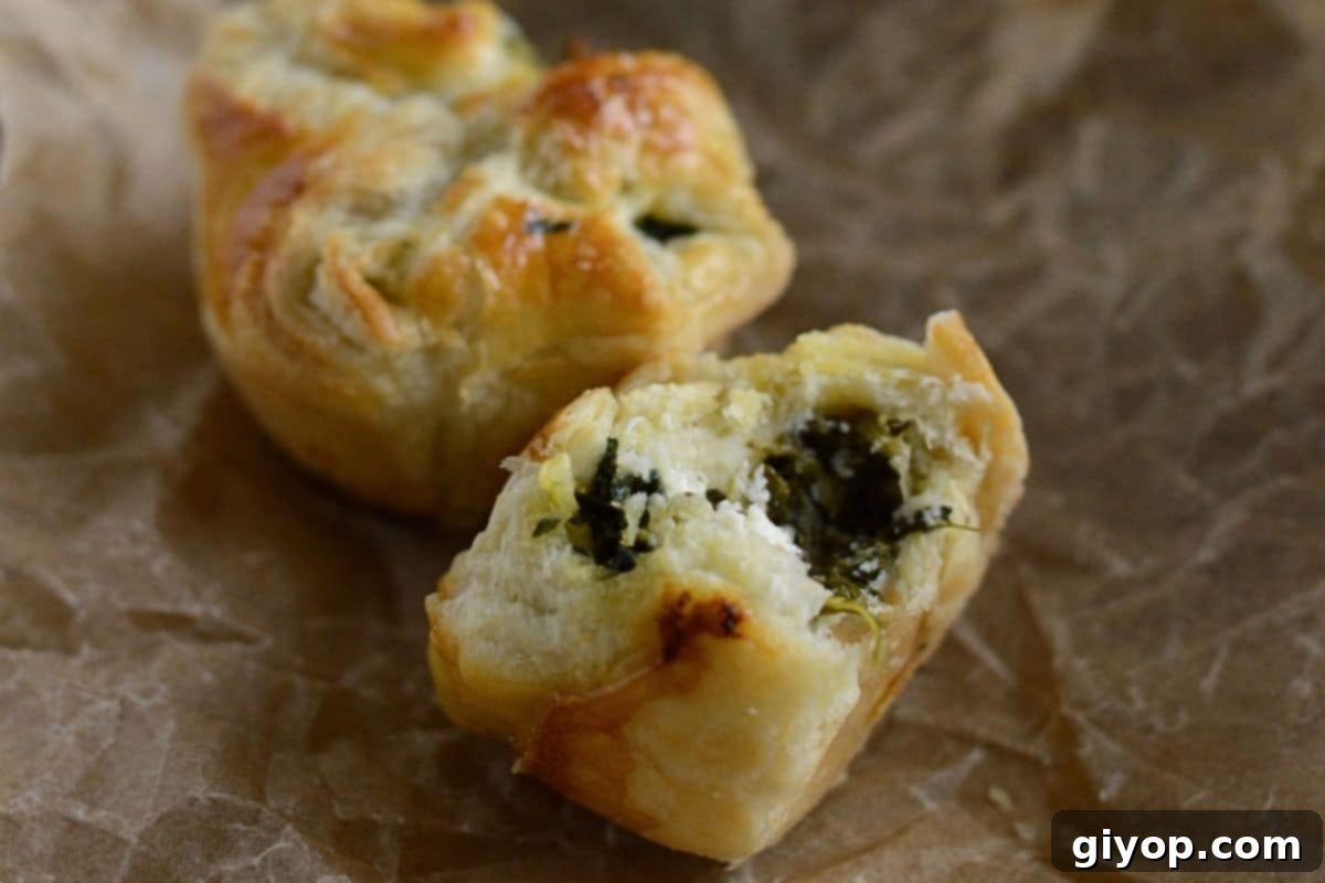 Spanakopita puff cut in galf to show filling.