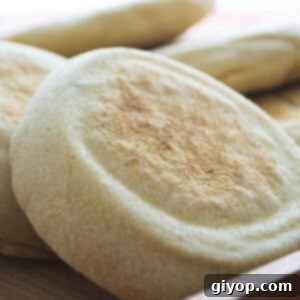 Soft and Fluffy Moroccan Batbout 2 A stack of golden brown batbout bread, ready to be served.