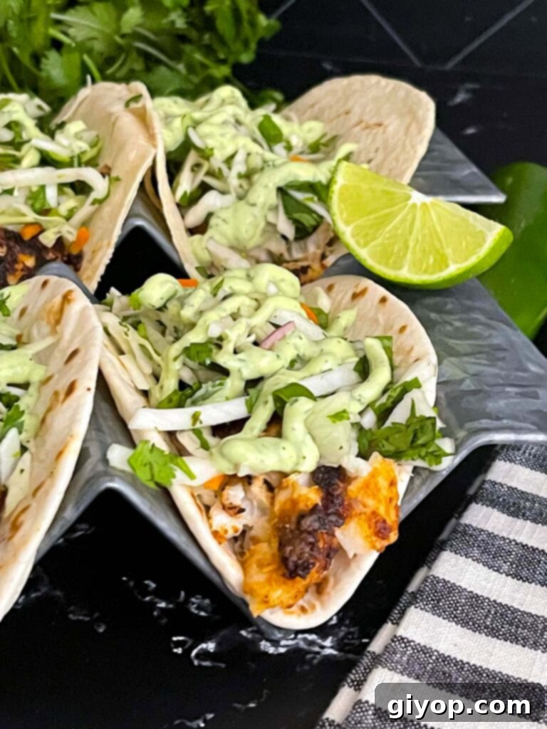 Fiery Blackened Fish Tacos 14 Close-up of a single Blackened Fish Taco on a dark background, highlighting the blackened fish and vibrant toppings.