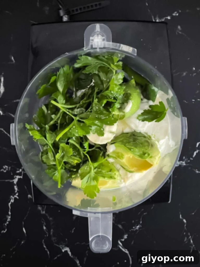 Fiery Blackened Fish Tacos 6 Ingredients for avocado sauce placed in a food processor.