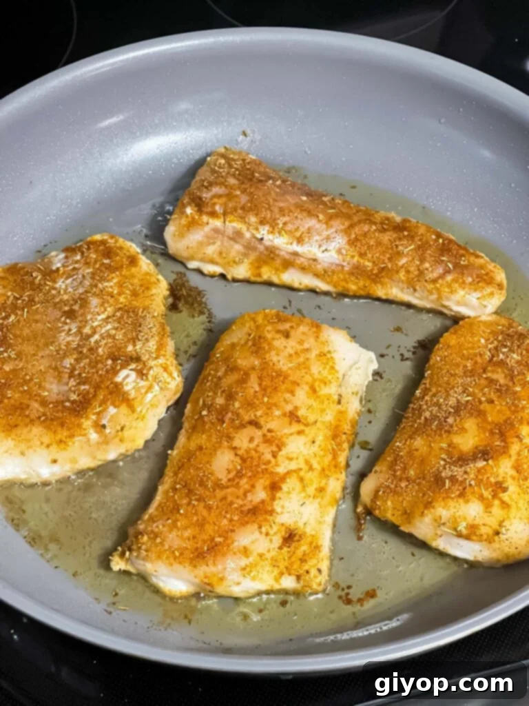 Fiery Blackened Fish Tacos 10 Fish cooking in a skillet, starting to blacken.