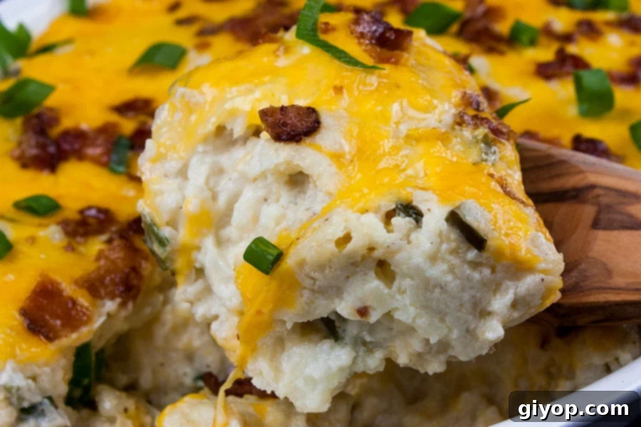 Loaded Cauliflower Mash Casserole with a serving being removed.