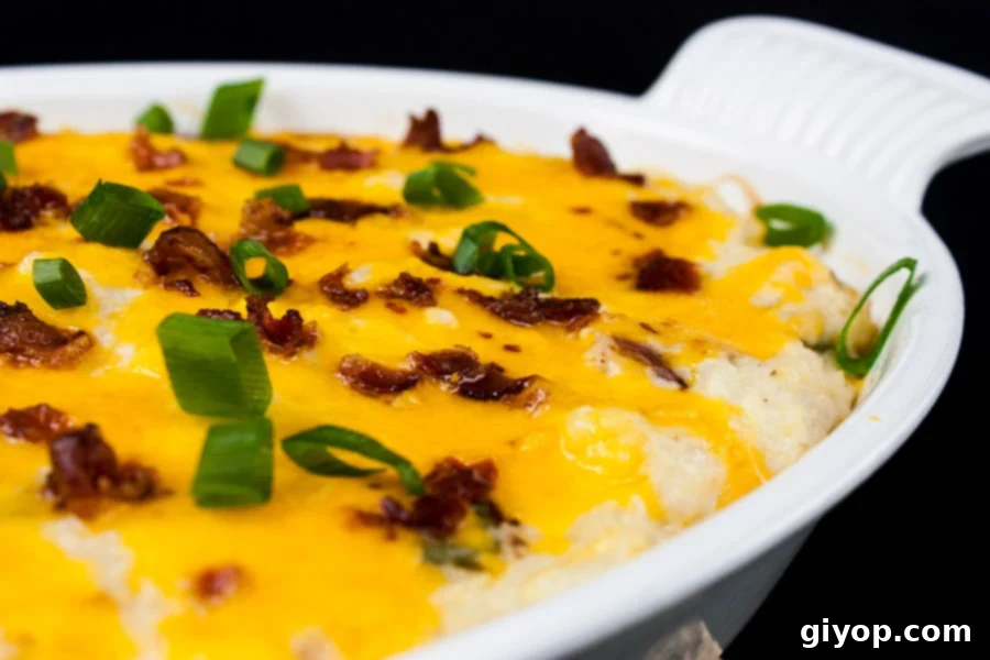 Loaded Cauliflower Mash Casserole - Perfect swap out for twice baked potatoes. It's unbelievably tasty and full of the loaded baked potato flavors you crave!