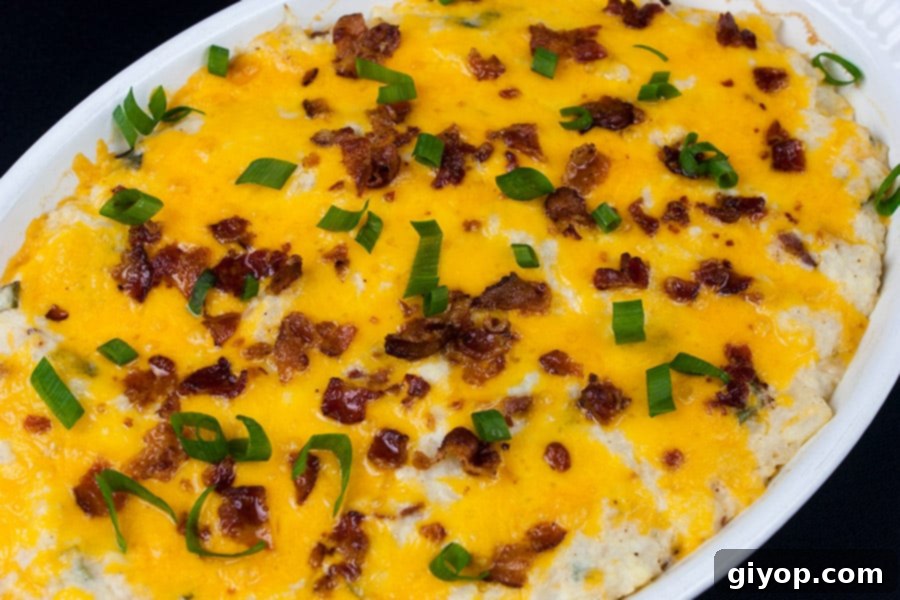Loaded Cauliflower Mash Casserole baked in a white casserole dish
