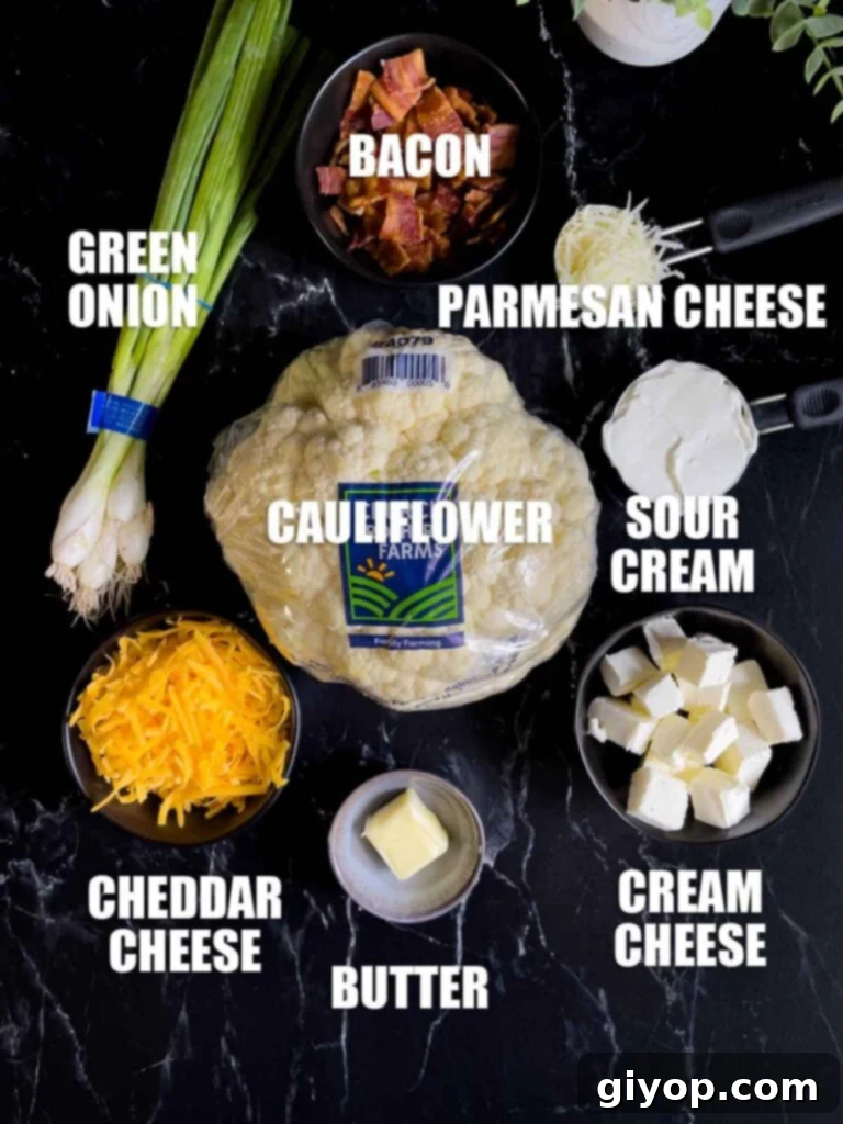 Ingredients for Loaded Cauliflower Mash Casserole on a dark surface.