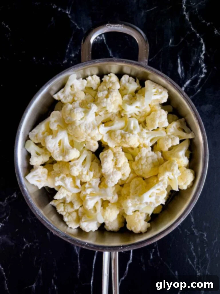 Cut cauliflower in a large pot.
