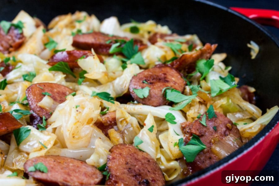 Fried cabbage and sausage in a skillet.