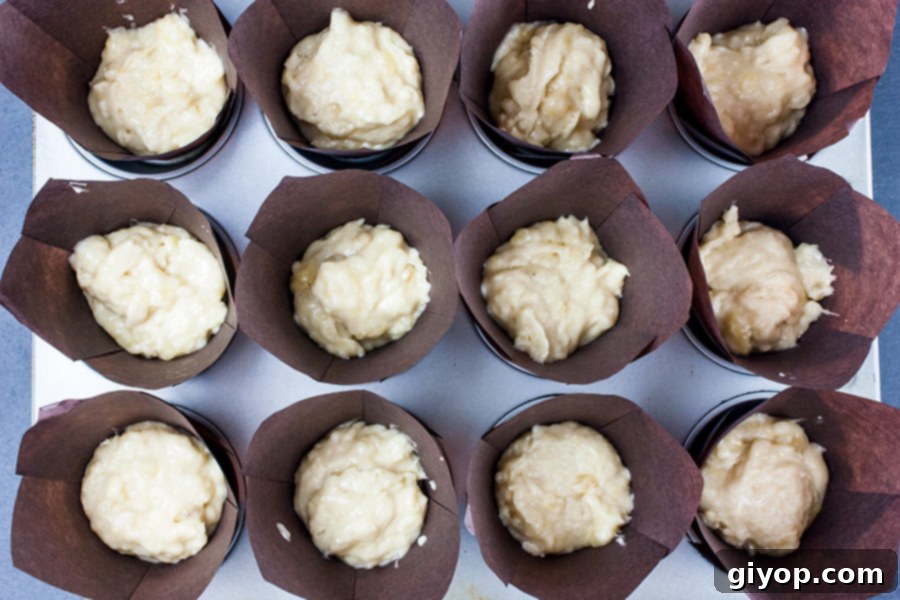 Irresistible Banana Muffins 3 Best Ever Banana Muffins - muffin liners filled with batter, ready for baking.