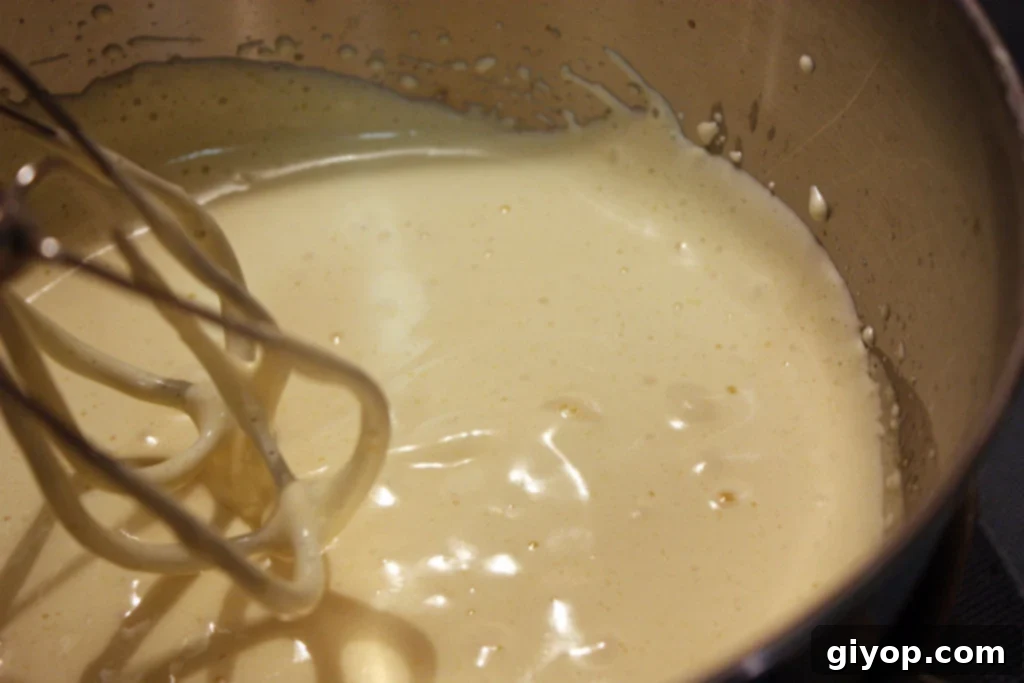 Effortless Tiramisu No Ladyfingers 3 Smooth, golden Genoise cake batter resting in a mixing bowl, ready to be transformed into the perfect Tiramisu base.