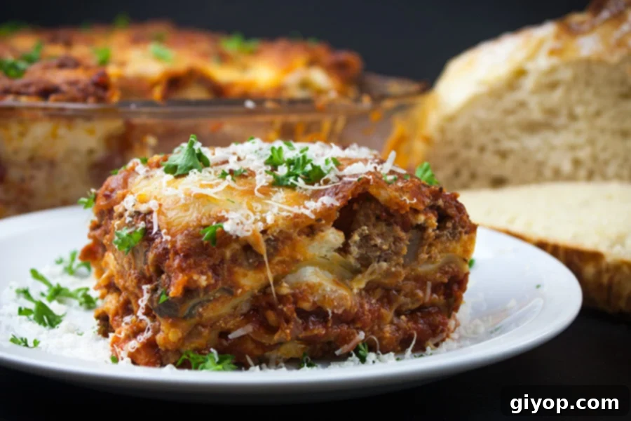 Absolute Best Ever Lasagna - The ultimate lasagna! Three layers of deliciously rich, luscious meat sauce, creamy cheesy ricotta and perfectly cooked noodles. With a trick to getting a perfect portion cut every time.