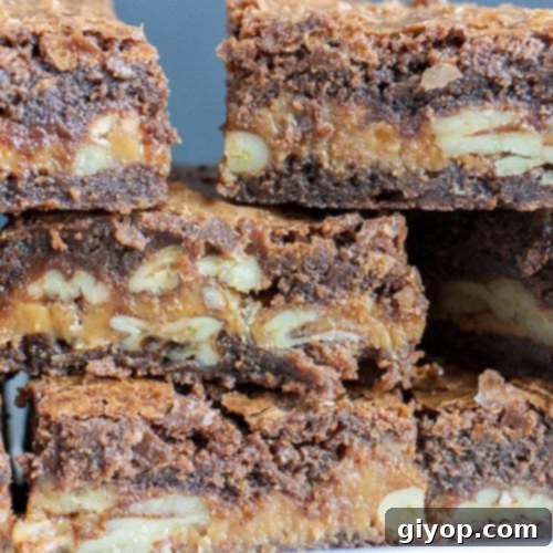 Supreme Turtle Indulgence 3 Ultimate Turtle Brownies stacked high, showing gooey caramel and pecans.