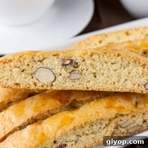 The Ultimate Vanilla Almond Biscotti 3 Almond Biscotti stacked on a white plate.