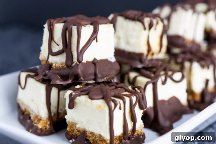 Chocolate Covered Cheesecake Bites stacked on a white plate, showcasing their inviting appearance.