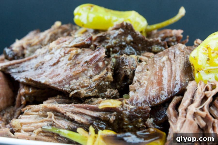 Melt-in-Your-Mouth Mississippi Pot Roast 5 Close-up shot of shredded Crock Pot Mississippi Pot Roast, showcasing its succulent texture and rich gravy.
