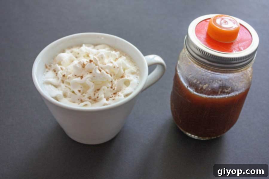 Pumpkin spice latte in a white coffee mug topped with whipped cream.