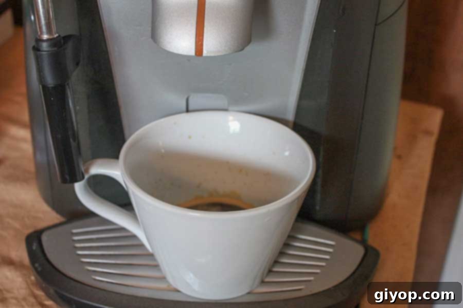 Espresso being pulled into a white cup.