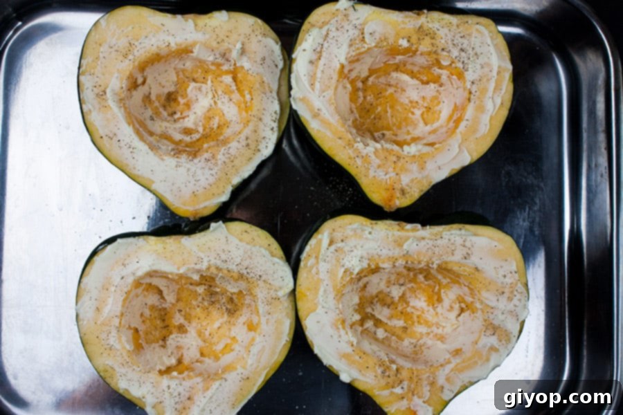 Perfectly Roasted Acorn Squash Recipe 3 Raw acorn squash halves brushed with melted butter and seasoned with salt and pepper, placed cut-side up in a roasting pan with water.