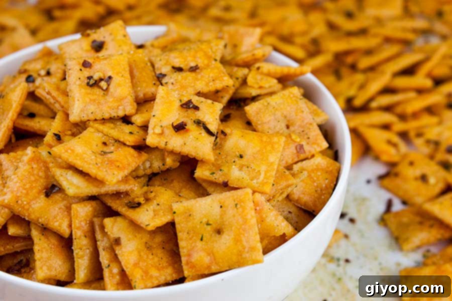 A close-up view of the perfectly baked and seasoned Firecracker Cheez-Itz in a white serving bowl.