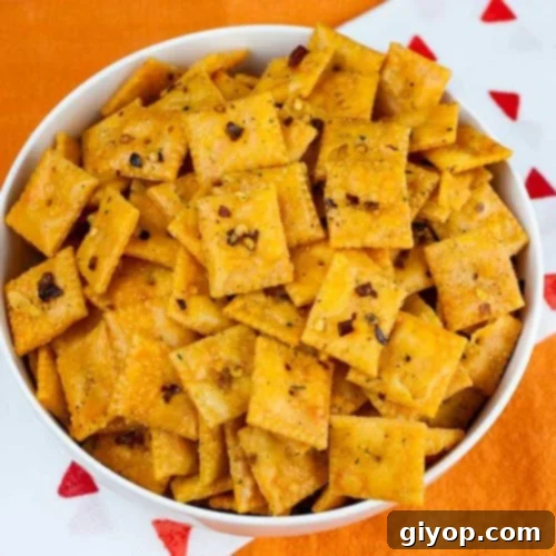 Firecracker Cheez-Itz in a white bowl on an orange table cloth.