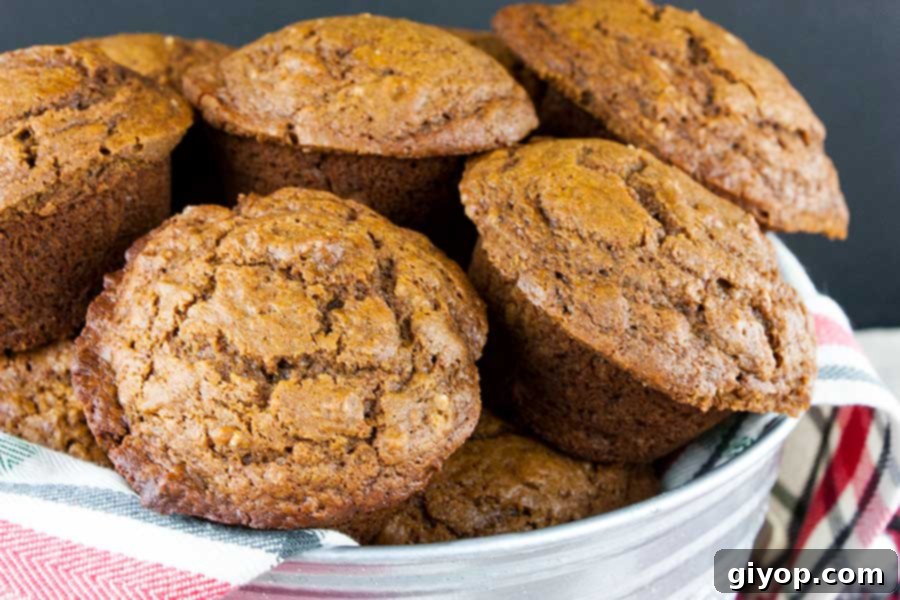 A collection of gingerbread muffins presented in a decorative metal bucket, highlighting their cozy, homemade appeal.