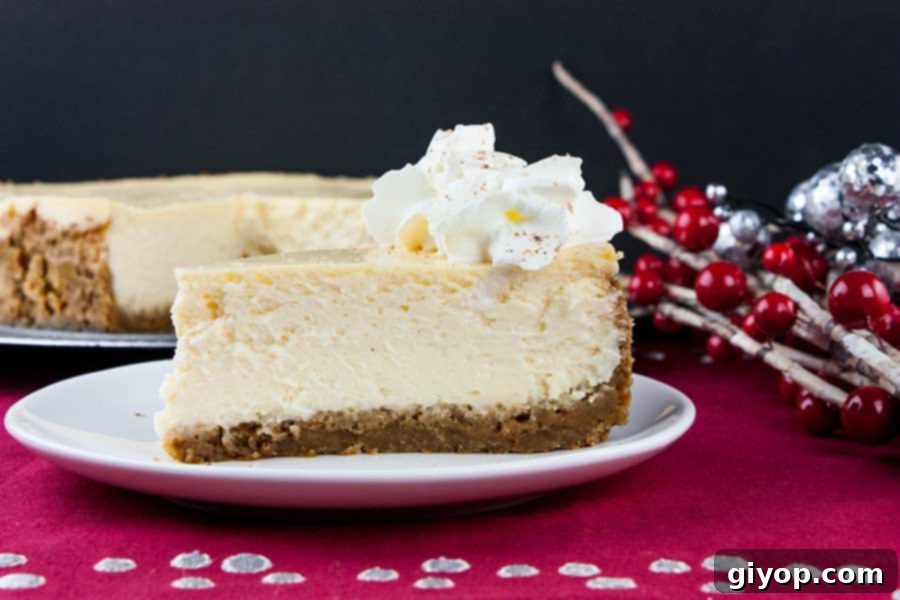 A perfectly baked eggnog cheesecake slice, showcasing its creamy texture and gingersnap crust, on a clean white plate.