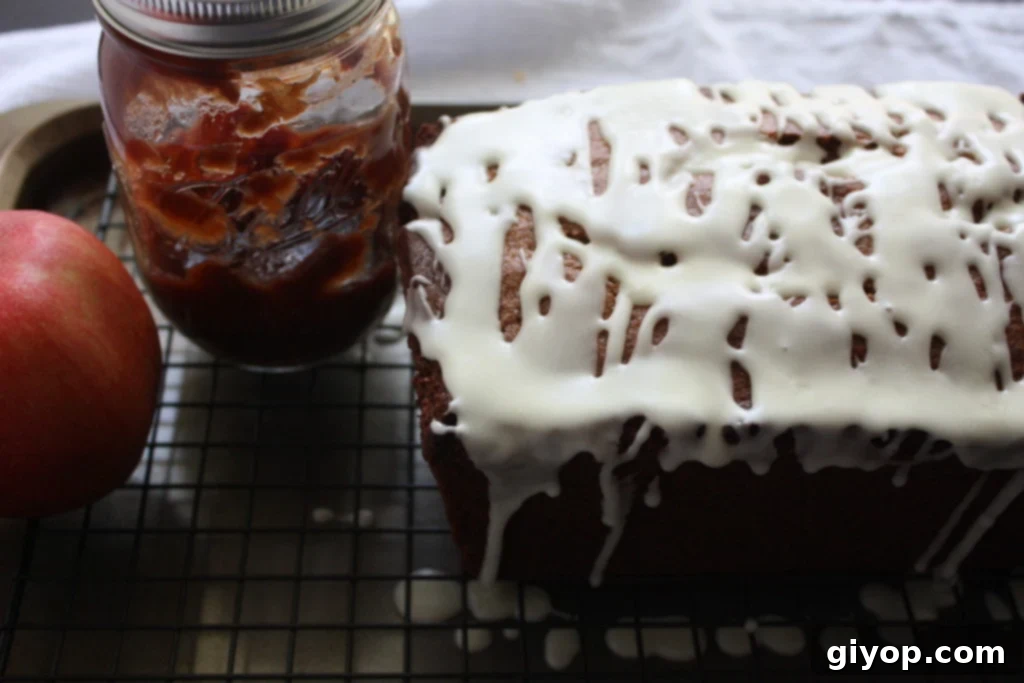 Freshly baked apple butter bread cooling on a wire rack, ready to be sliced.