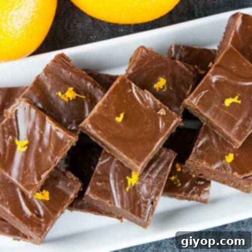A perfectly portioned square of chocolate orange fudge, ready to be enjoyed as a delightful treat.