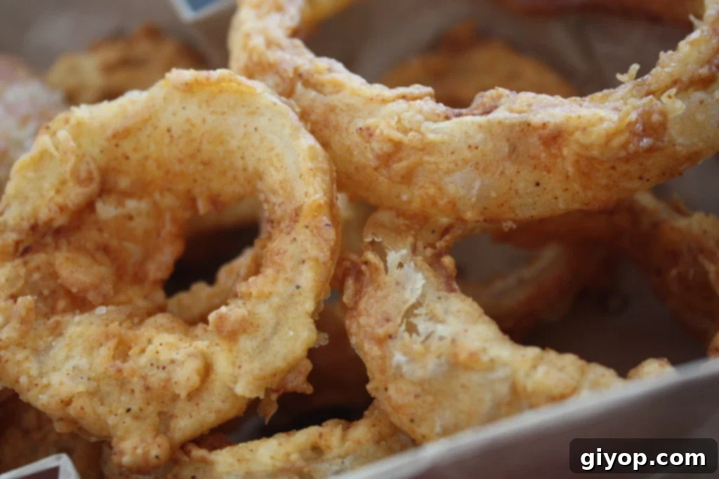 Beer battered onions rings in a basket.