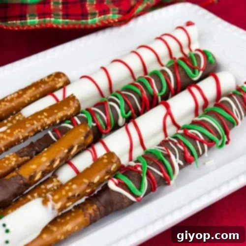 Chocolate covered pretzel rods on an oblong platter.