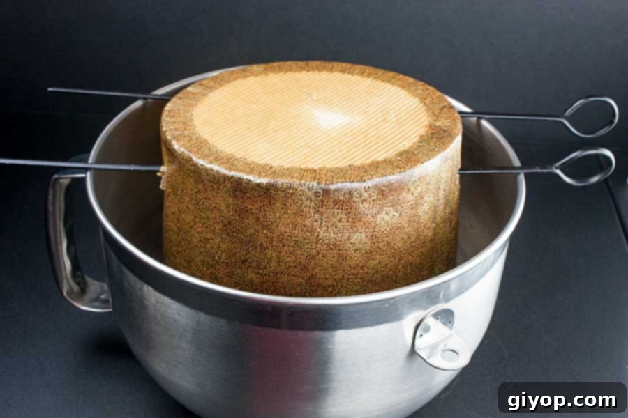 The baked panettone hung upside down in a large deep metal bowl to cool.