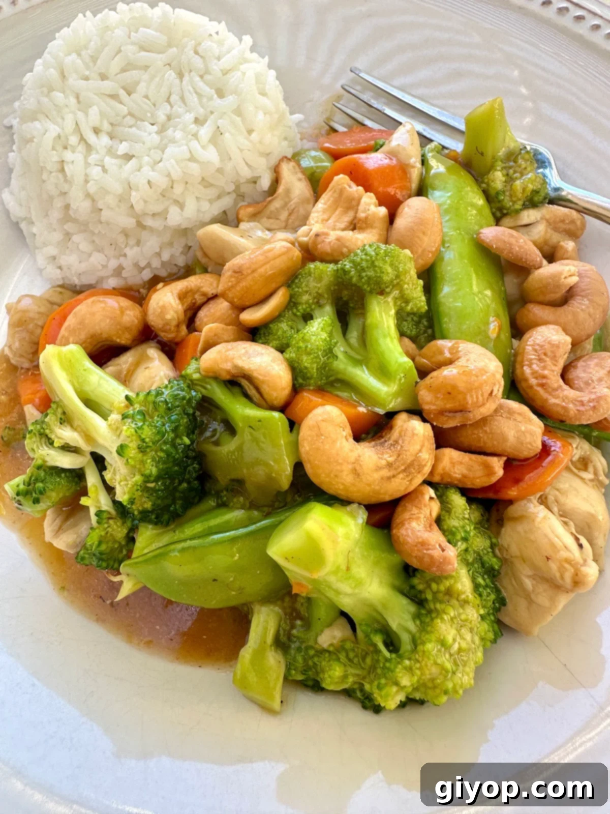 A serving of cashew chicken stir fry with rice.