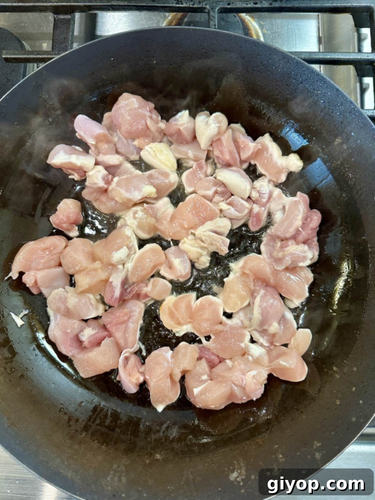 Chicken cooking in a pan.