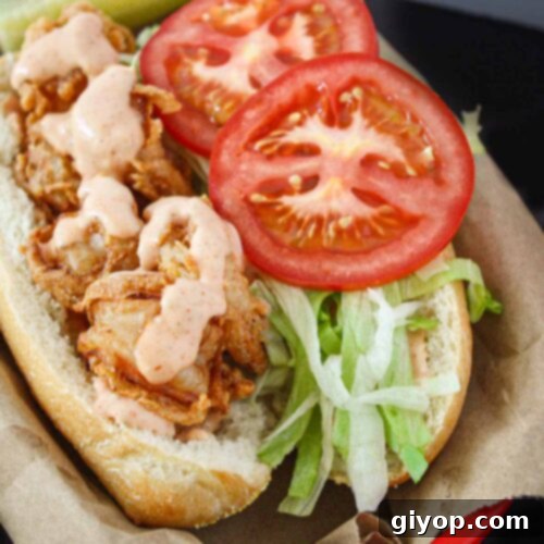 Shrimp po'boy in a brown paper-lined red basket.
