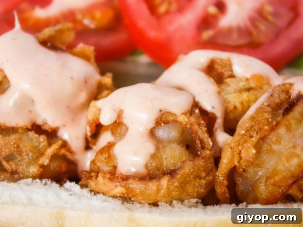 Crispy fried shrimp Po' Boy sandwich, served in a red basket lined with brown paper, ready to be enjoyed.