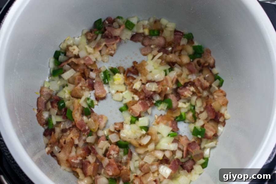 A close-up shot of the savory Ninja Foodi Mexican Pinto Beans (Charro Beans) stew, showcasing the rich texture and vibrant colors of the ingredients.