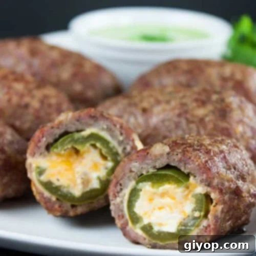 Smoky Keto Armadillo Eggs 8 Smoked keto armadillo eggs on a white platter with garnish.