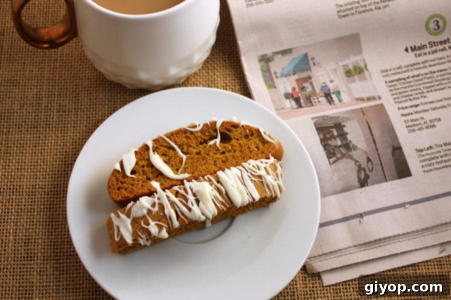 Autumn Spice Latte Biscotti 7 Beautifully drizzled Pumpkin Spice Latte Biscotti arranged on a pristine white plate, showcasing the elegant white chocolate finish.